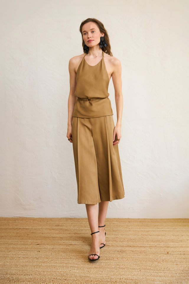 A model wearing a beige Tencel midi skirt with a matching top, standing against a neutral background.