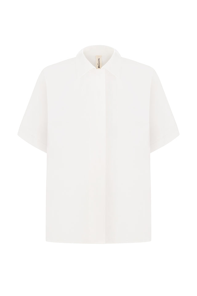 A white, short-sleeved men's shirt with a hidden bar and a button-up neck.