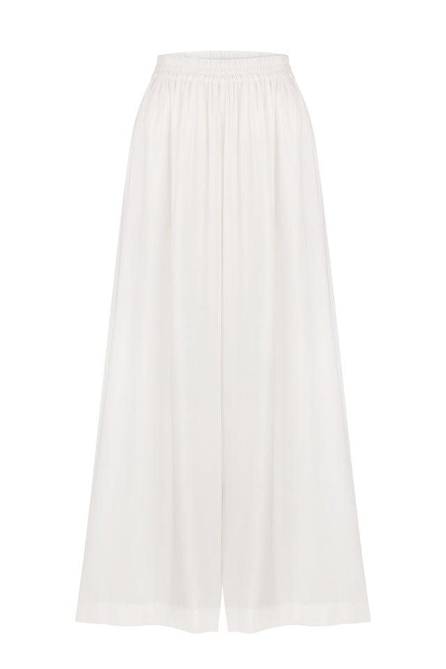 A pair of white wide-leg trousers made of cotton, with an elastic band at the waist for comfort.