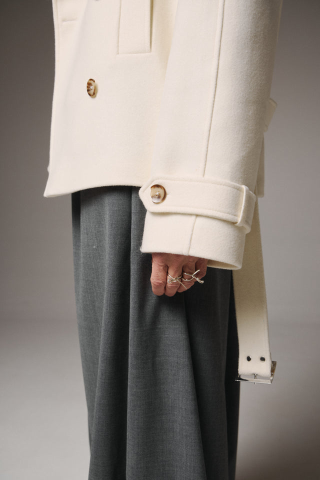 Person wearing a mustard yellow outfit against a blue background